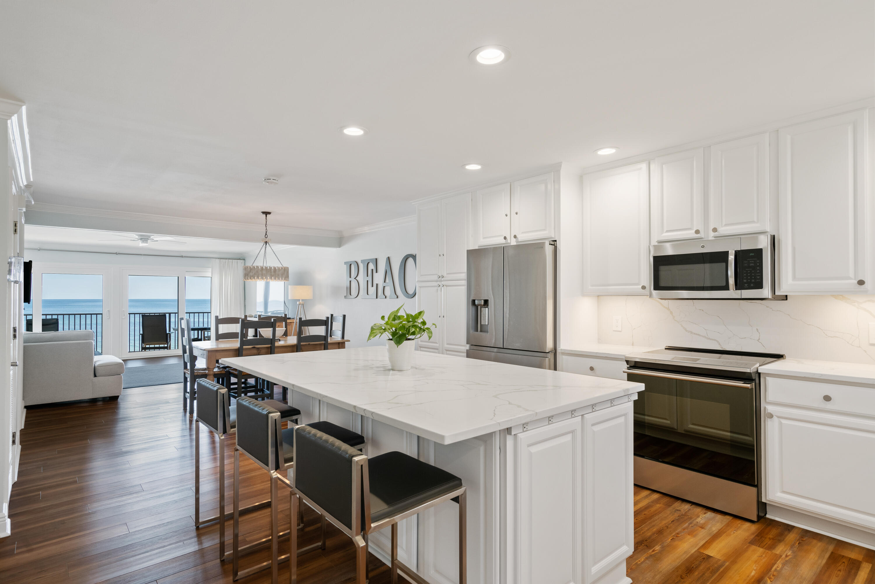 214 Blue Mountain Road, Unit 121 Santa Rosa Beach, FL 32459 - Photo 1 of 39 a kitchen with stainless steel appliances a stove a sink a microwave a center island and a refrigerator