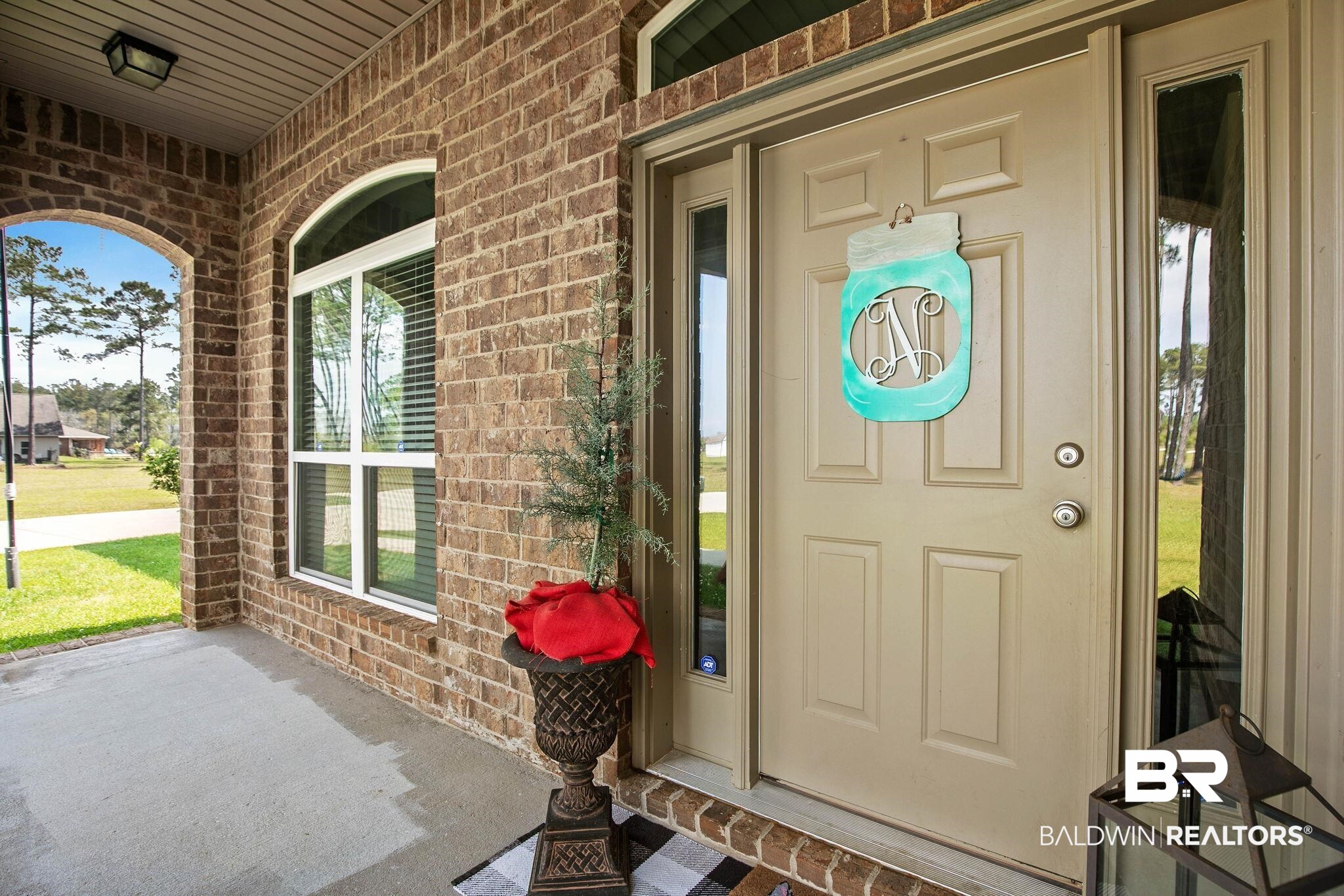 12750 B Jenkins Pit Road Daphne, AL 36527 - Photo 4 of 89 View of exterior entry featuring a porch and brick siding