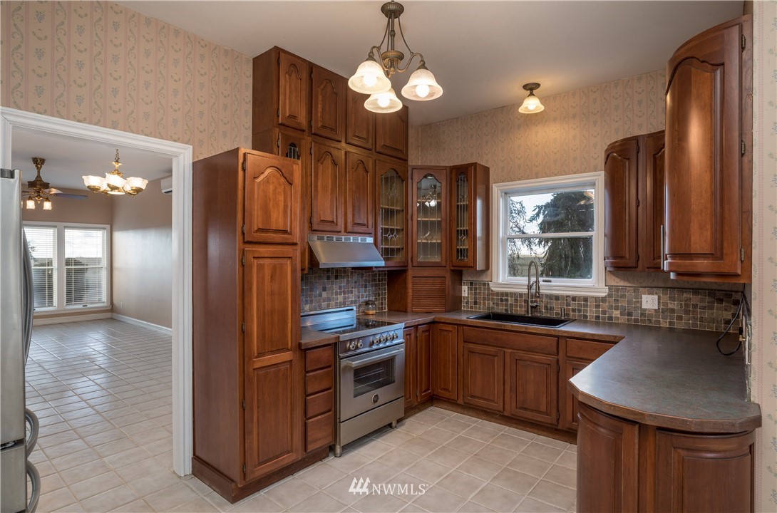 890 South Lucy Road Othello, WA 99344 - Photo 3 of 40 a kitchen with stainless steel appliances granite countertop a sink and a refrigerator