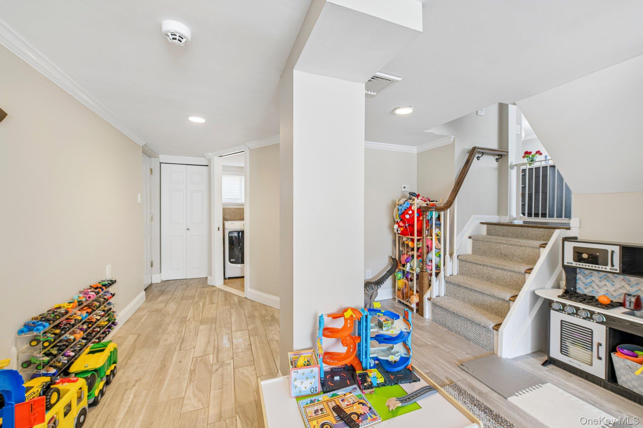 2821 Colonial Avenue Merrick, NY 11566 - Photo 24 of 29 a view of a hallway with wooden floor and stairs