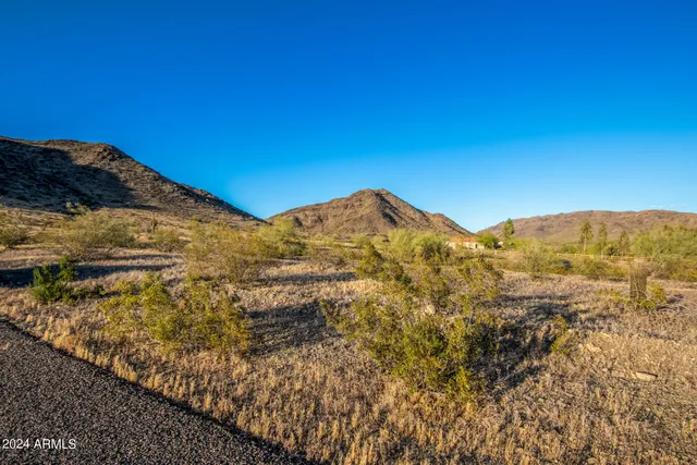a view of a large building with mountains in the background