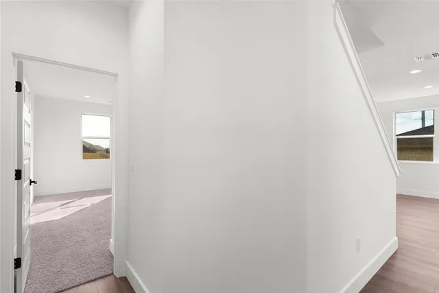 a bathroom with a granite countertop toilet a sink and a mirror