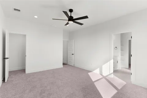 a view of a room with window and ceiling fan