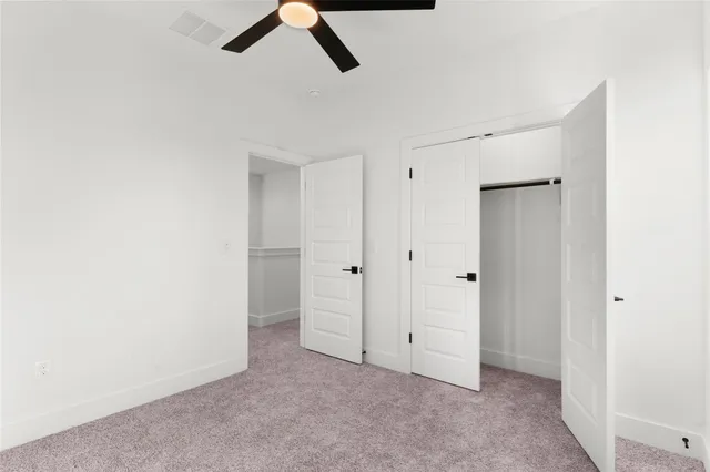 a view of a house with wooden fence