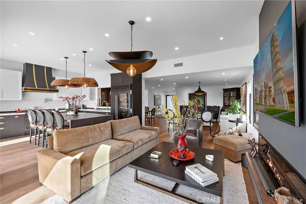 a living room with furniture and a chandelier