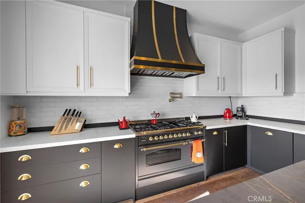 a kitchen with a stove a sink and a microwave