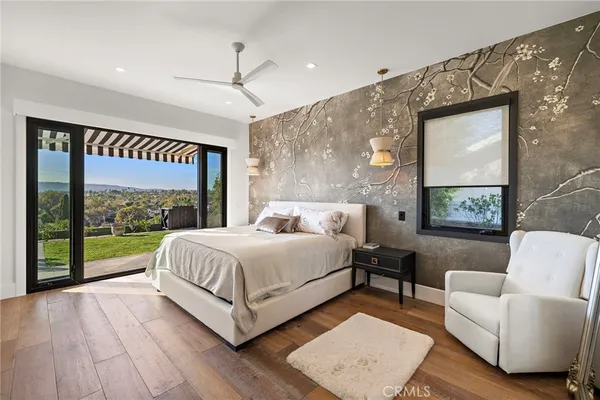 a spacious bedroom with a bed couch and a window
