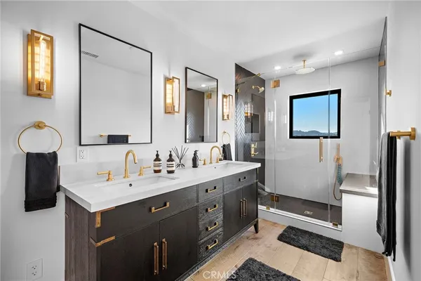 a bathroom with a double vanity sink mirror and toilet