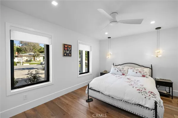 a bedroom with a bed and a painting on the wall