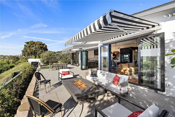 a view of a patio with table and chairs and potted plants