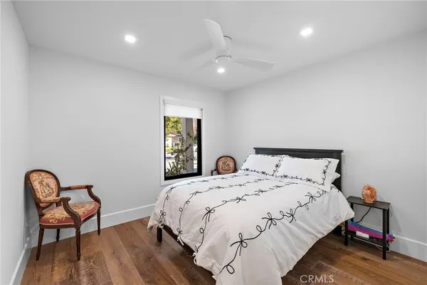 a bedroom with a bed and a chair