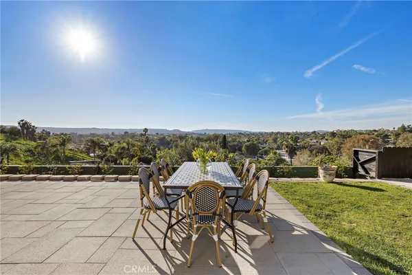 a view of a terrace with furniture and city view