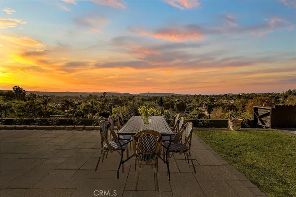 a view of a terrace with furniture and city