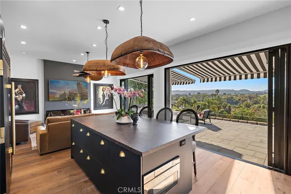 a kitchen with stainless steel appliances granite countertop a sink a stove and a wooden floors