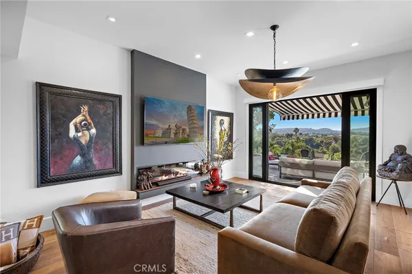 a living room with furniture and a chandelier