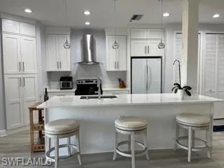 a kitchen with kitchen island cabinets and chairs