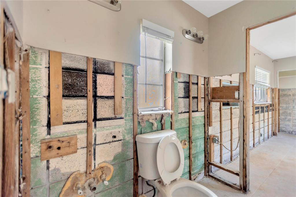 16214 3rd Street East Redington Beach, FL 33708 - Photo 18 of 30 a bathroom with a granite countertop sink mirror vanity and toilet