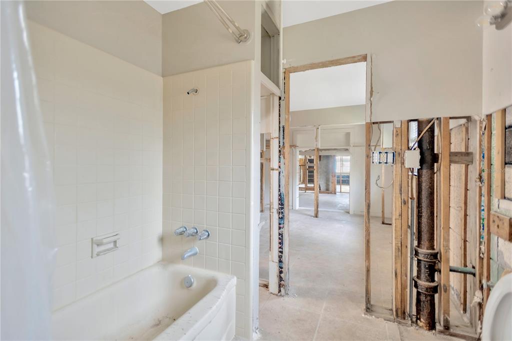 16214 3rd Street East Redington Beach, FL 33708 - Photo 19 of 30 a bathroom with a tub shower and closet