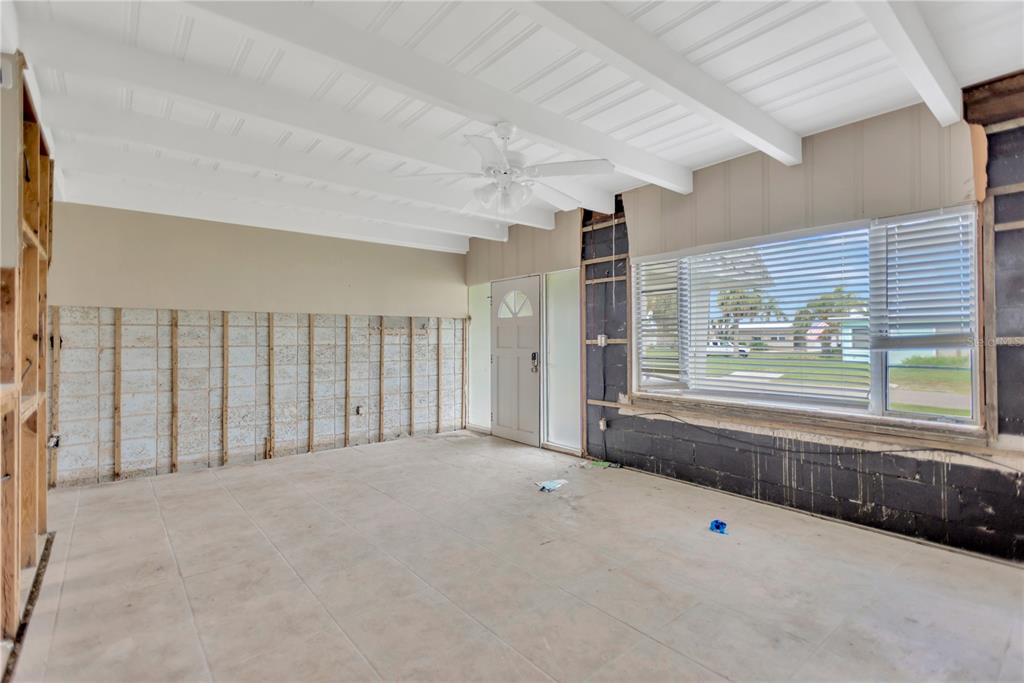 16214 3rd Street East Redington Beach, FL 33708 - Photo 6 of 30 an empty room with a fireplace and windows
