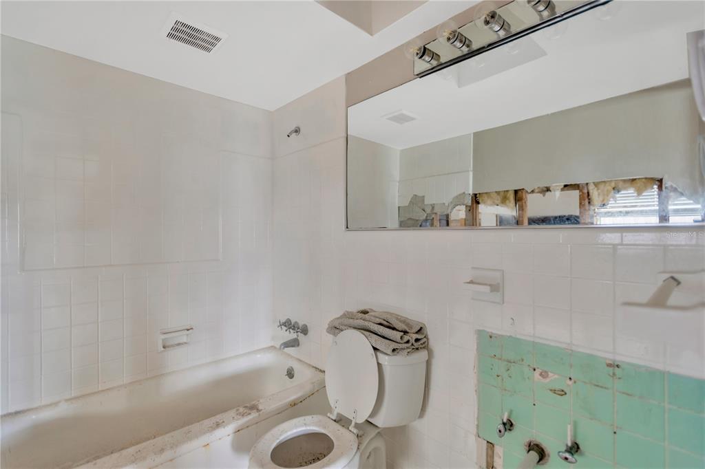 16214 3rd Street East Redington Beach, FL 33708 - Photo 9 of 30 a bathroom with a tub sink and mirror
