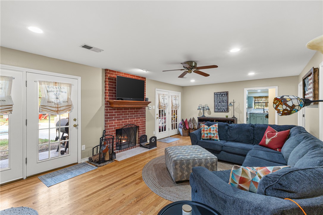 31928 Reids Prairie Road Waller, TX 77484 - Photo 18 of 43 Living area featuring a fireplace, recessed lighting, wood finished floors, and a ceiling fan