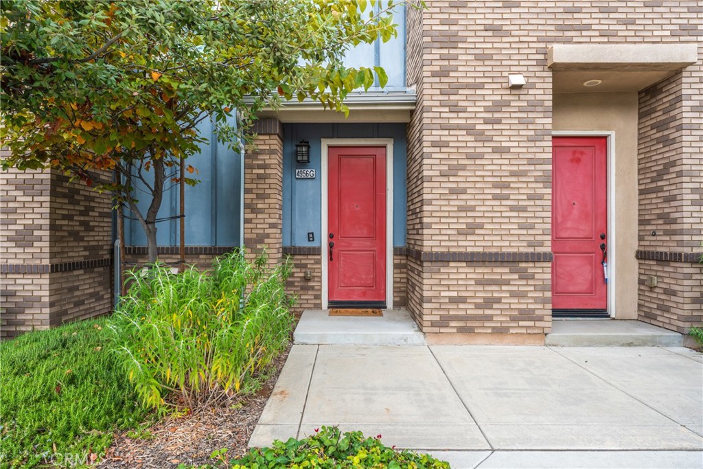 4956 Arrow Highway, Unit G Montclair, CA 91763 - Photo 1 of 32 a front view of a house with a garage