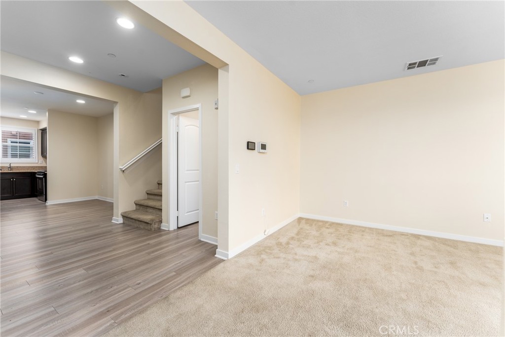 4956 Arrow Highway, Unit G Montclair, CA 91763 - Photo 15 of 32 an empty room with wooden floor and windows