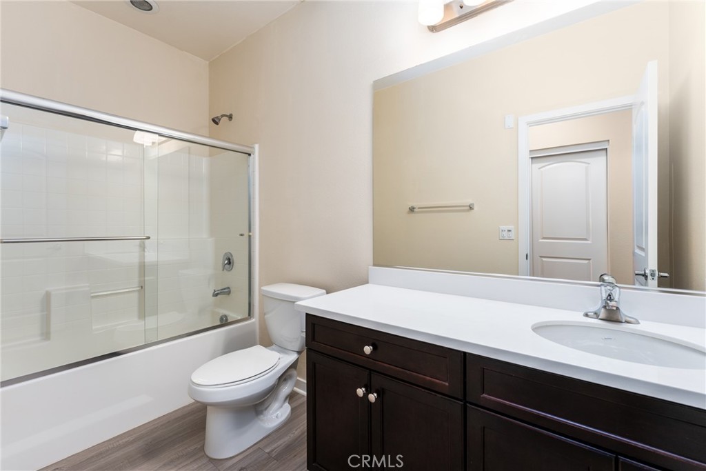 4956 Arrow Highway, Unit G Montclair, CA 91763 - Photo 21 of 32 a bathroom with a sink a toilet a shower and a mirror