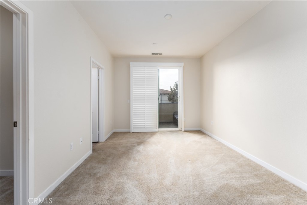 4956 Arrow Highway, Unit G Montclair, CA 91763 - Photo 22 of 32 an empty room with a window and a fireplace