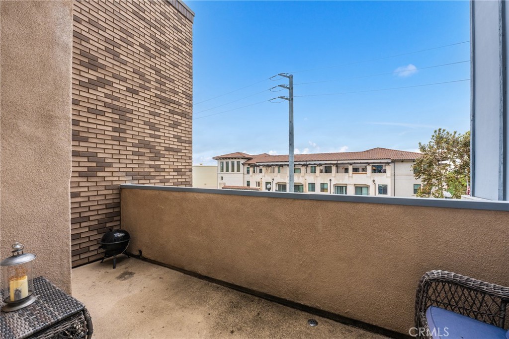 4956 Arrow Highway, Unit G Montclair, CA 91763 - Photo 23 of 32 a view of a balcony with wooden floor and a bench