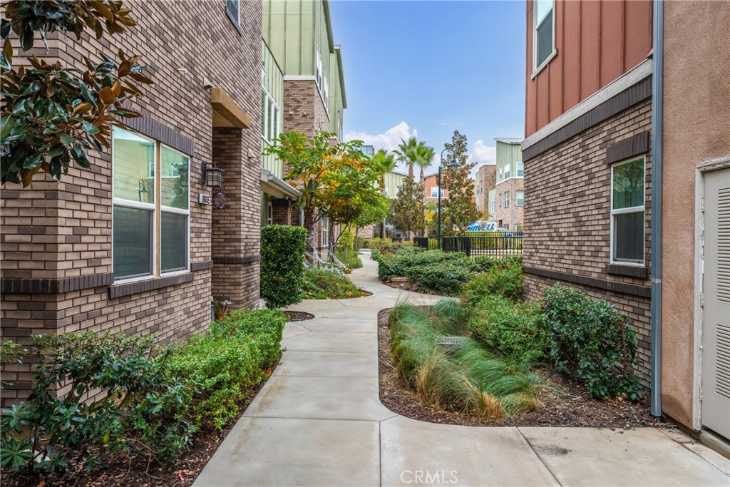 4956 Arrow Highway, Unit G Montclair, CA 91763 - Photo 3 of 32 a front view of a house with a yard