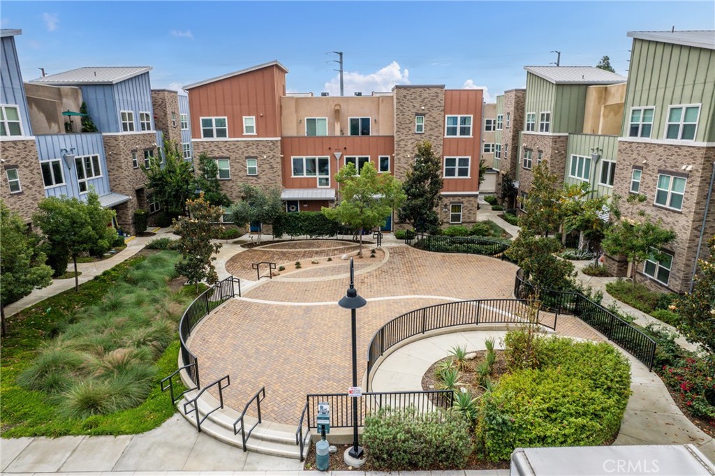 4956 Arrow Highway, Unit G Montclair, CA 91763 - Photo 5 of 32 a view of a community park with multi story residential apartment building in the back