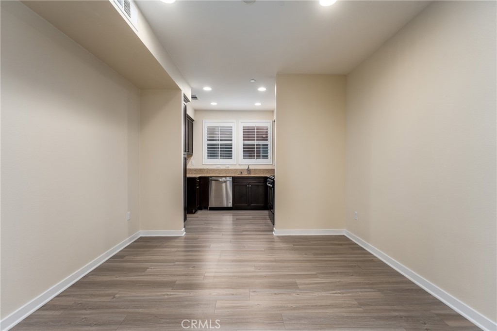 4956 Arrow Highway, Unit G Montclair, CA 91763 - Photo 10 of 32 a view of a big room with wooden floor and windows