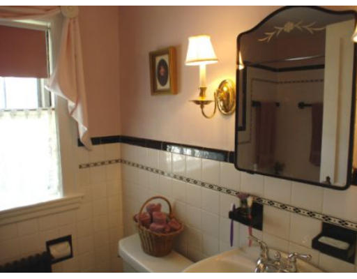 105 Spring Street Lexington, MA 02421 - Photo 12 of 18 a bathroom with a sink and a mirror