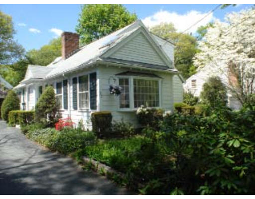 105 Spring Street Lexington, MA 02421 - Photo 16 of 18 a view of a house with potted plants and a bench