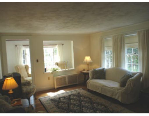 105 Spring Street Lexington, MA 02421 - Photo 2 of 18 a living room with furniture a lamp a rug and a large window