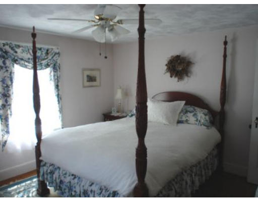 105 Spring Street Lexington, MA 02421 - Photo 8 of 18 a bedroom with a bed and a table