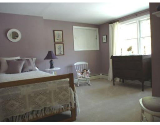 105 Spring Street Lexington, MA 02421 - Photo 9 of 18 a bedroom with furniture and a window