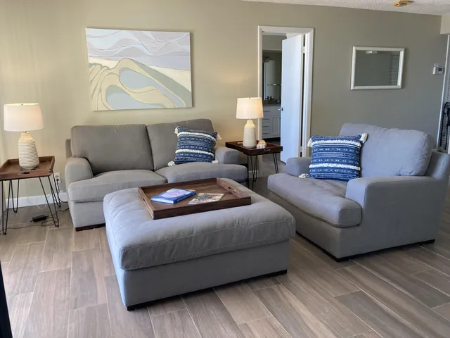 a living room with couches and painting on the wall