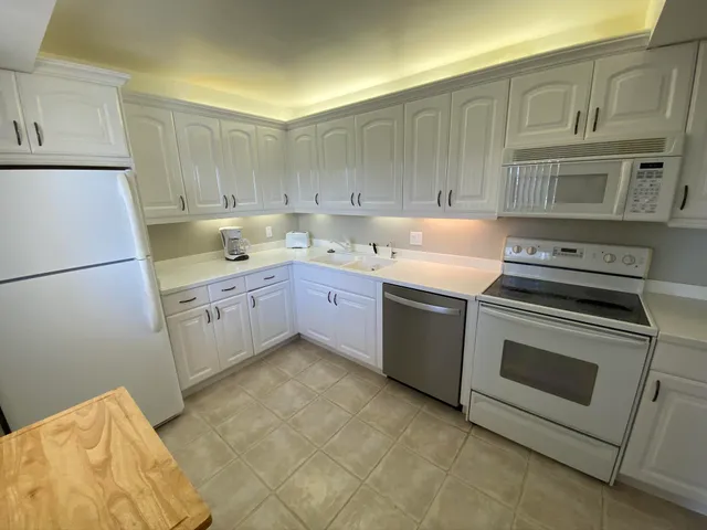 a kitchen with a sink stove and refrigerator