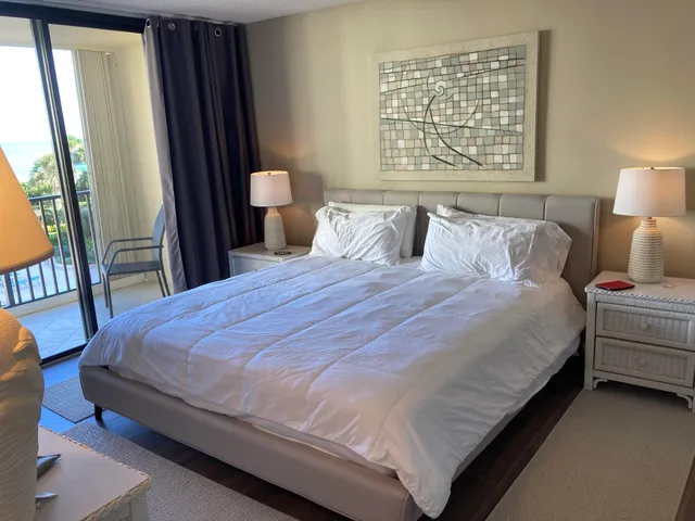 a large bed sitting in a bedroom next to a window