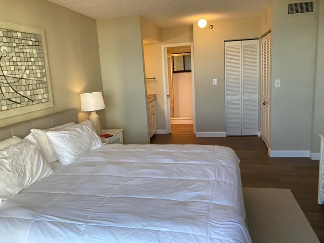 a bedroom with a bed and a lamp