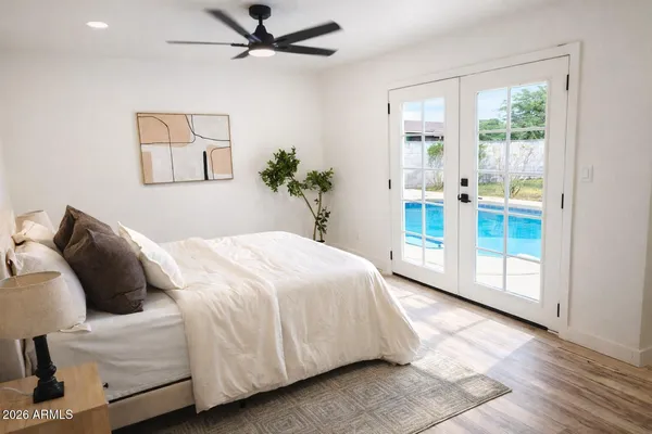 a bedroom with a large bed and a chandelier