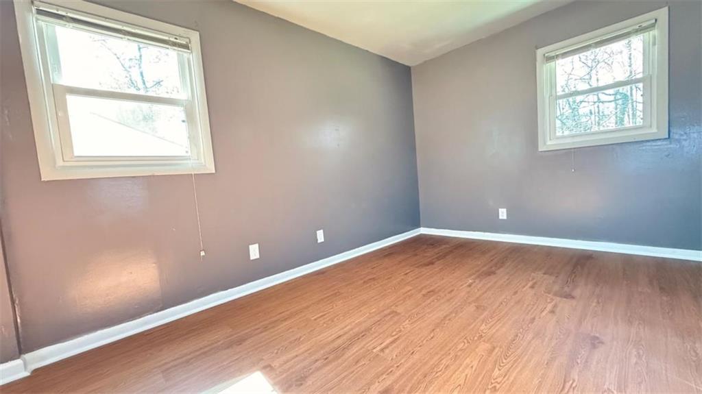 4183 O'Hara Road Forest Park, GA 30297 - Photo 11 of 24 an empty room with wooden floor and windows