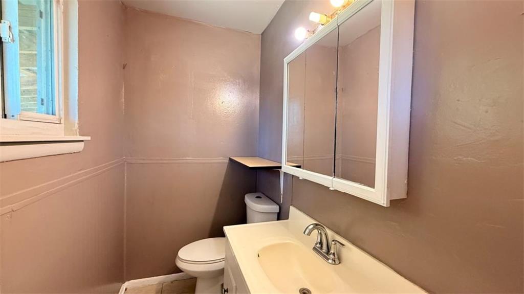 4183 O'Hara Road Forest Park, GA 30297 - Photo 14 of 24 a bathroom with a sink a toilet and mirror