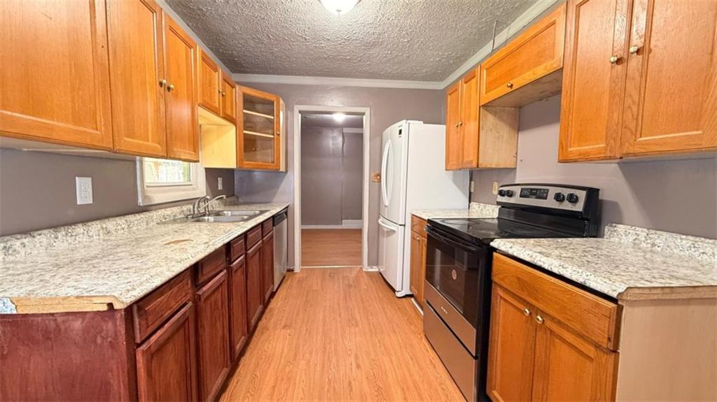 4183 O'Hara Road Forest Park, GA 30297 - Photo 17 of 24 a kitchen with a sink stove and cabinets