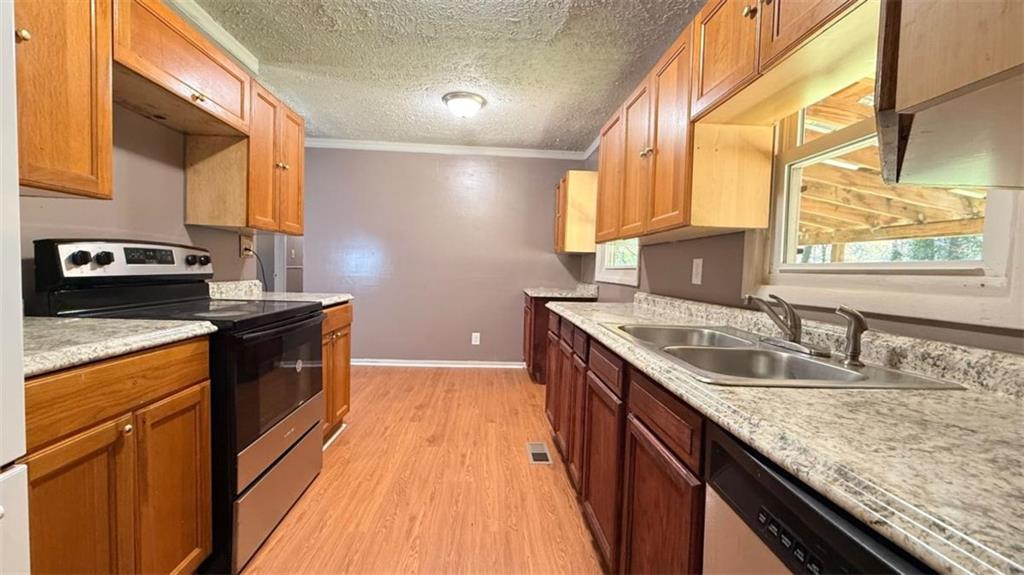 4183 O'Hara Road Forest Park, GA 30297 - Photo 18 of 24 a kitchen with a sink stove and cabinets