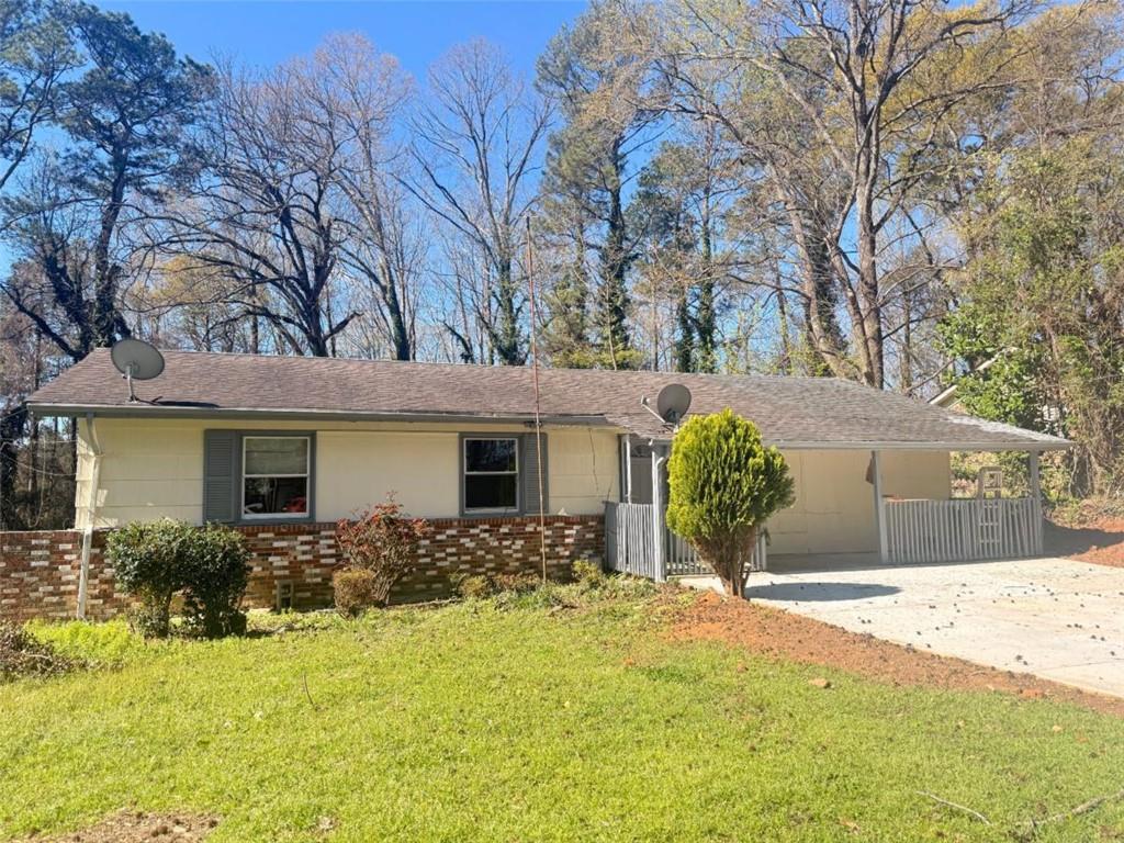 4183 O'Hara Road Forest Park, GA 30297 - Photo 2 of 24 a view of a house with snow on the tree and wooden fence