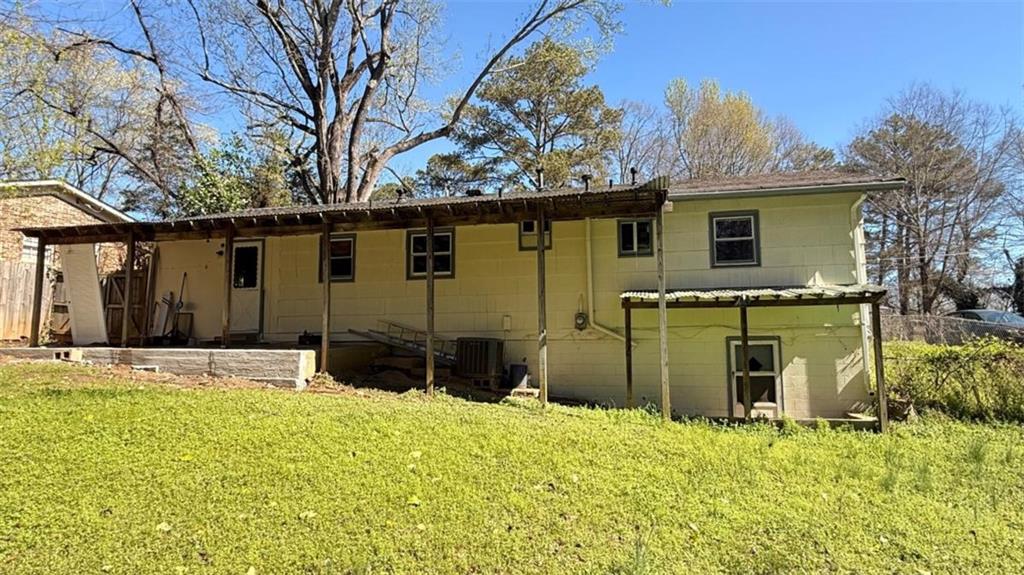4183 O'Hara Road Forest Park, GA 30297 - Photo 21 of 24 a yellow house with trees in front of it