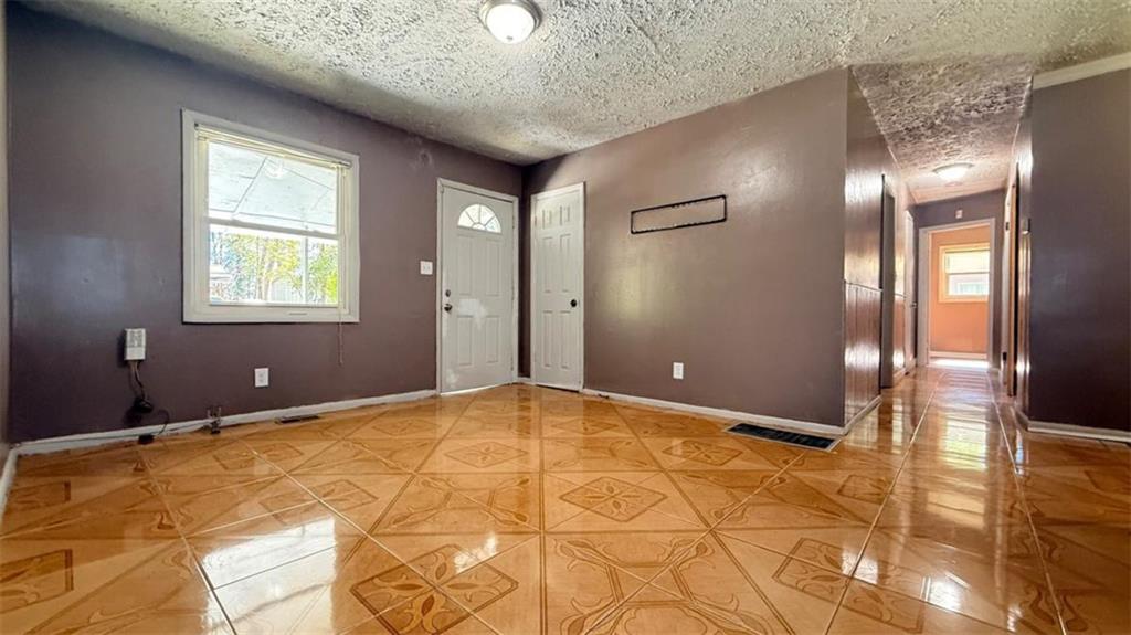 4183 O'Hara Road Forest Park, GA 30297 - Photo 4 of 24 a view of an empty room with window and wooden floor